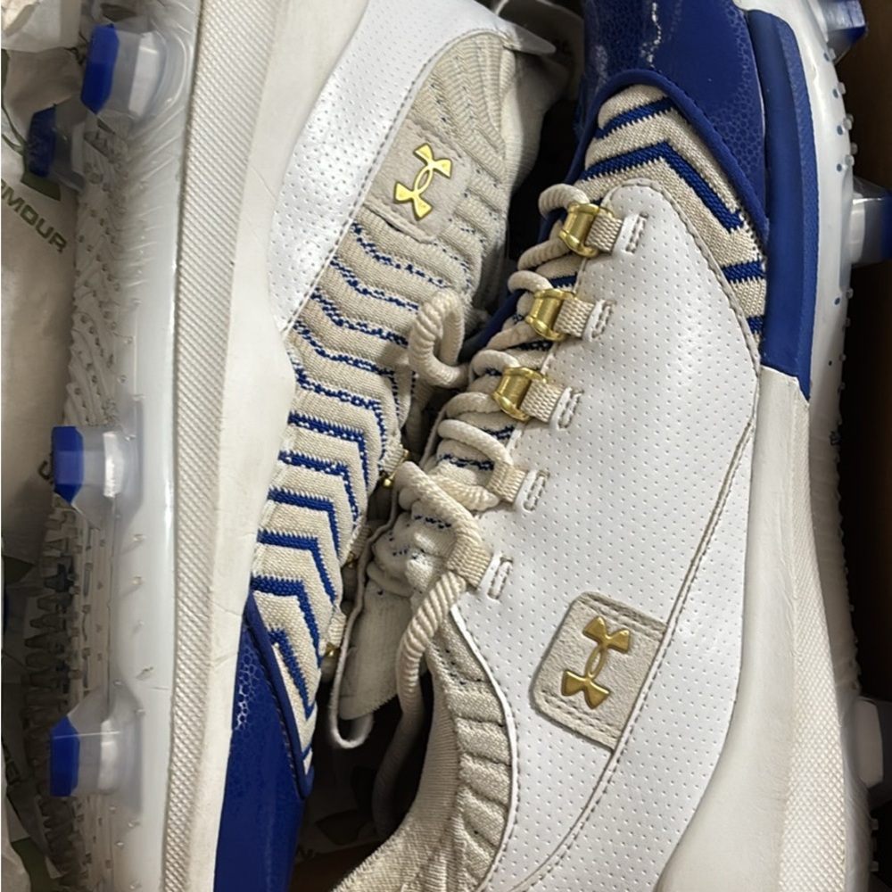 Under Armour White and Blue Sports Cleats with Gold Accents